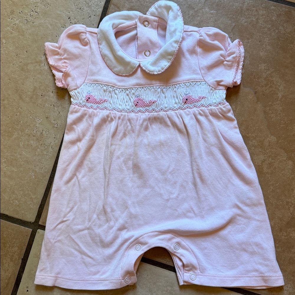 Smocked, collared pink baby romper with whale design